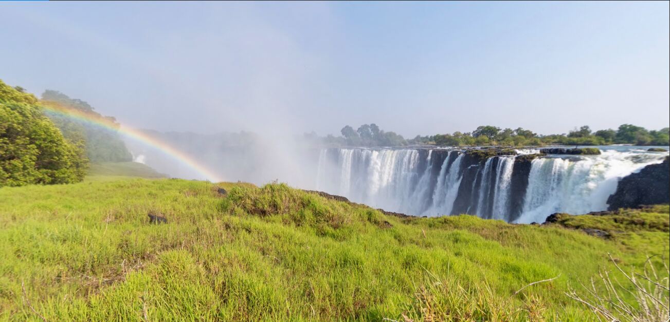 Travellers at a Victoria Falls viewpoint with an Intondolo guide